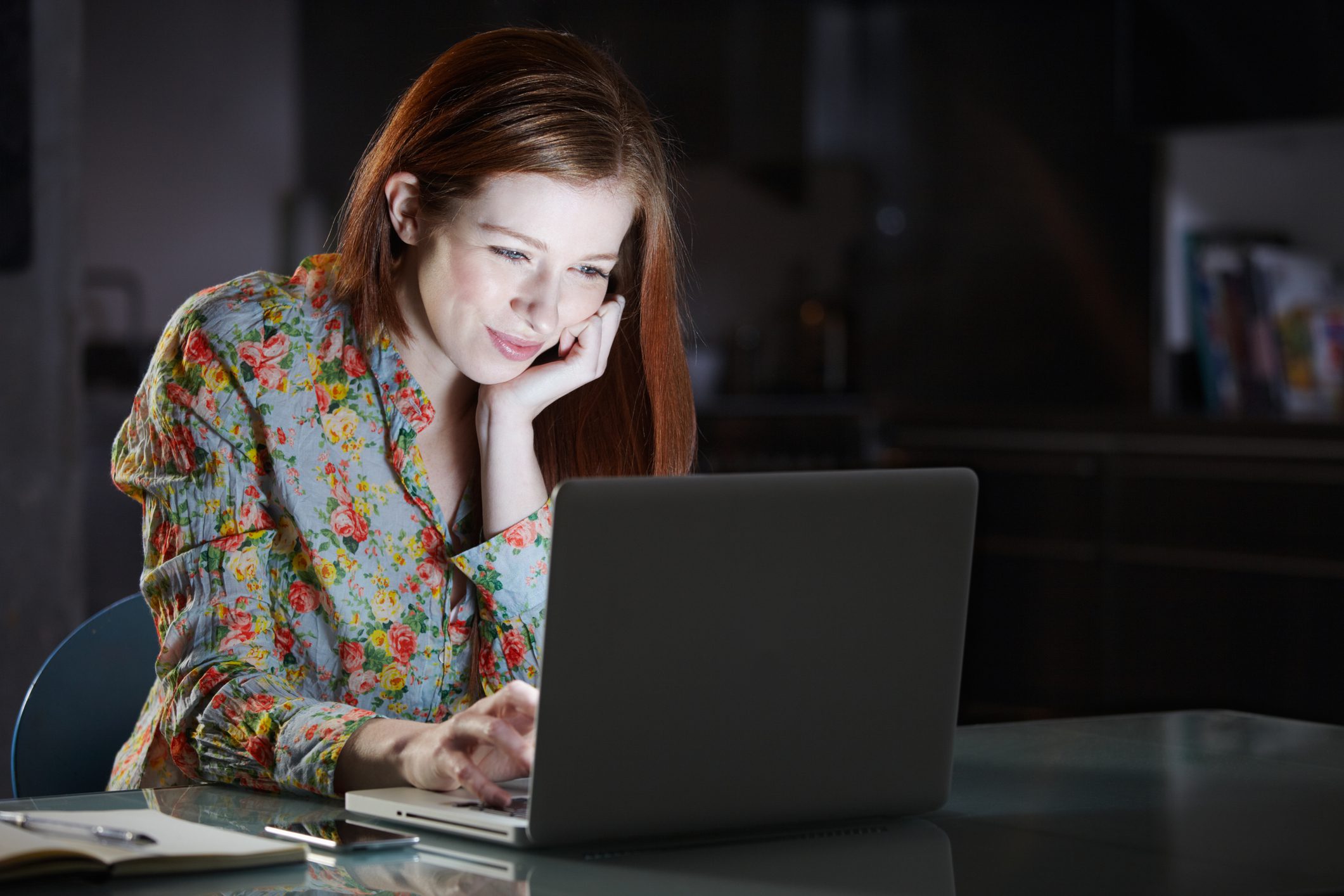 Woman using laptop at night