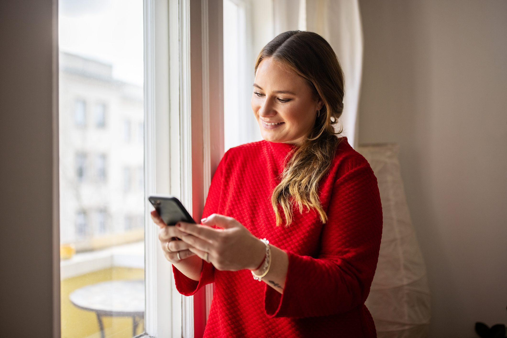 Woman smiling looking at her cell phone